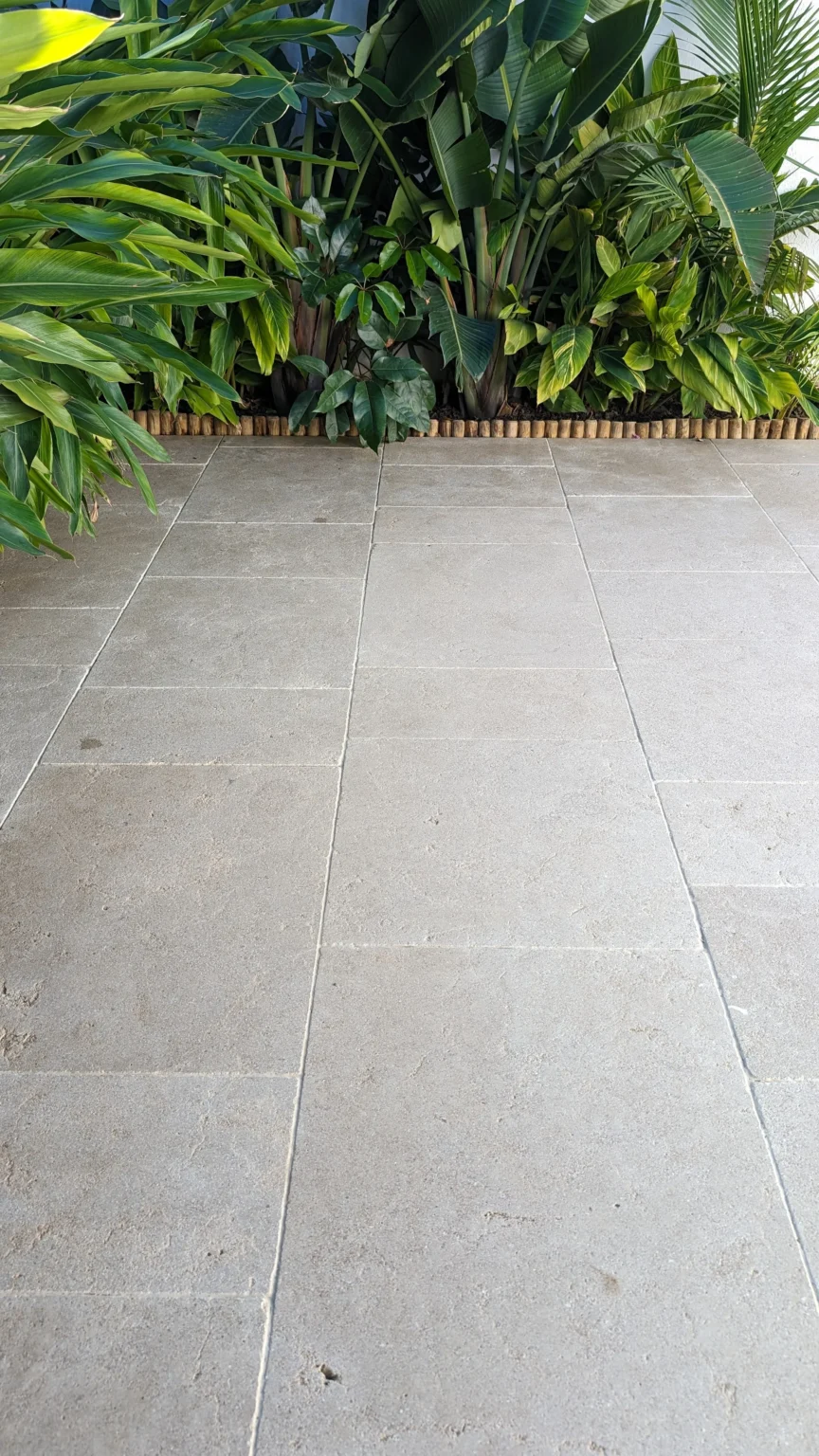 Limestone tiles with lush greenery backdrop by RMS Traders based on Melbourne Australia